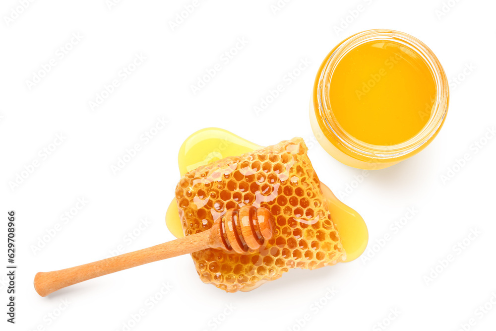 Bowl of sweet honey, dipper and comb on white background