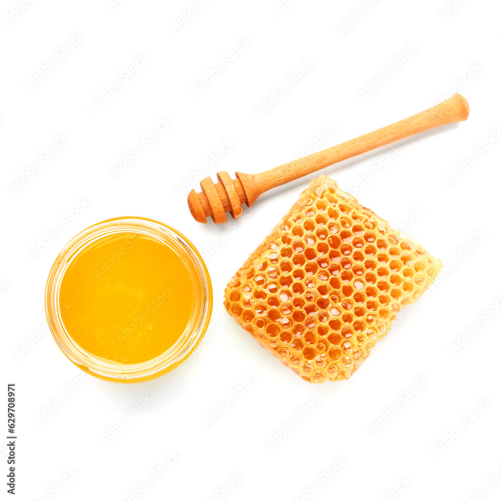 Bowl of sweet honey, dipper and comb on white background