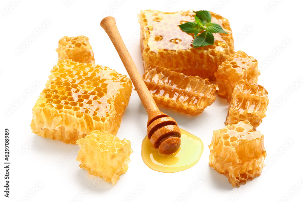 Sweet honeycombs and dipper on white background