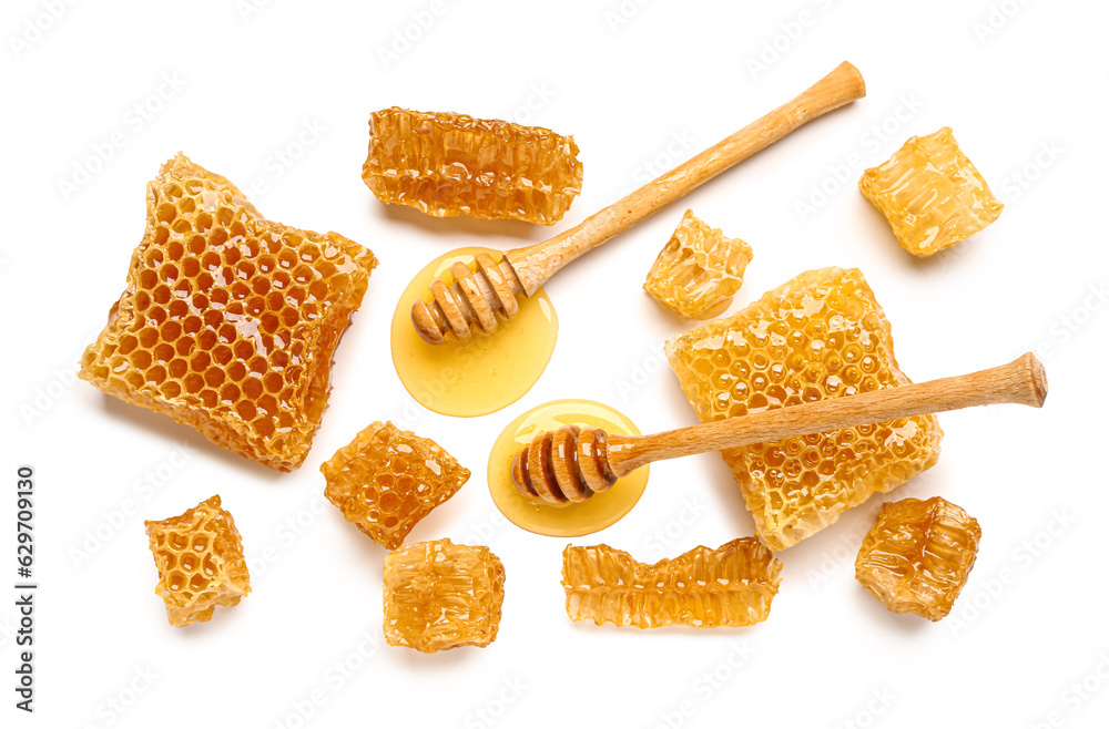 Sweet honeycombs and dippers on white background