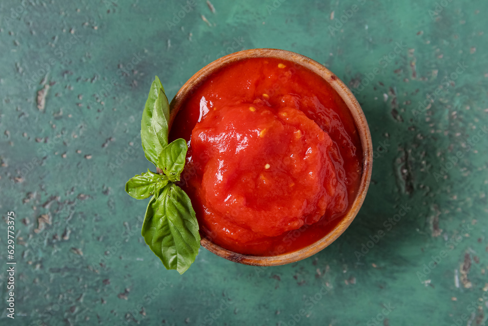 Bowl of canned tomatoes on color background