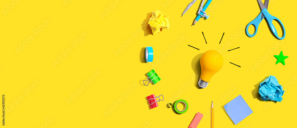 Idea light bulb with school supplies overhead view - flat lay