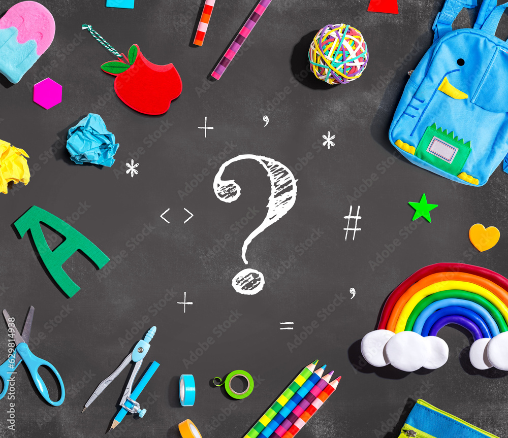 Question mark with school supplies on a chalkboard - flat lay