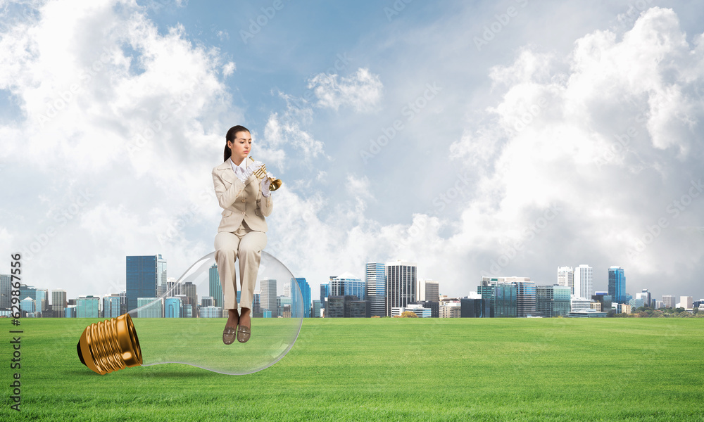 Attractive woman playing trumpet brass