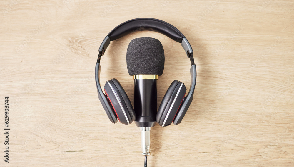 Audio, microphone and headphones on a table for a podcast, radio or broadcast. Music, above or music