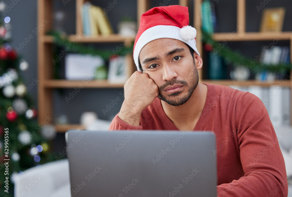 Bored, christmas hat and portrait of a tired man in the office with a laptop working on a project. B