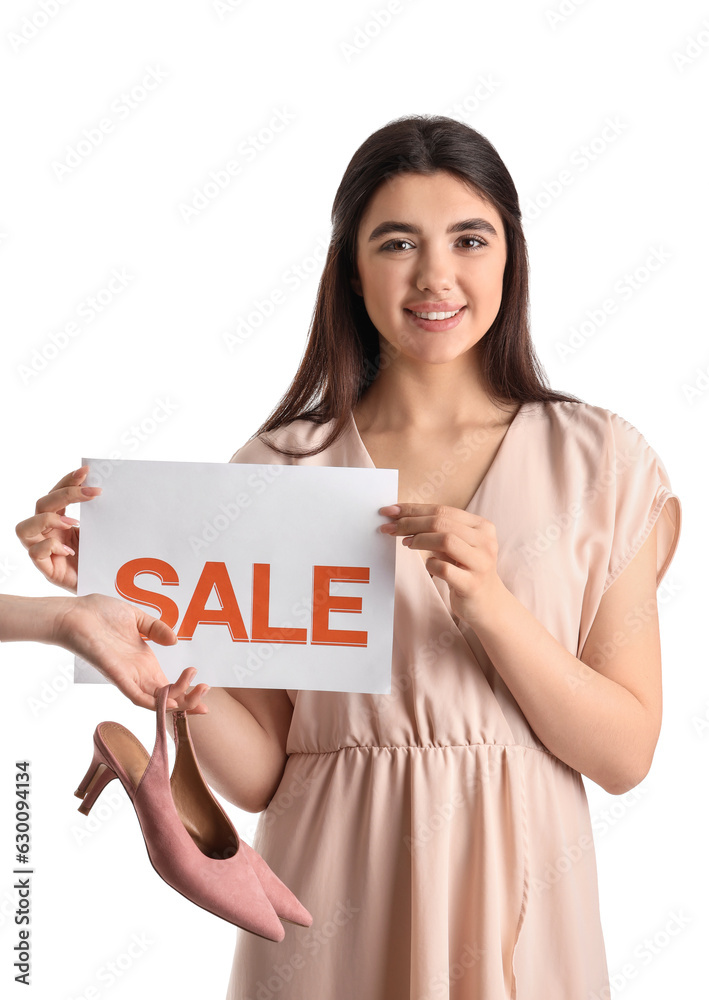 Female seller with sale sign and stylish shoes on white background