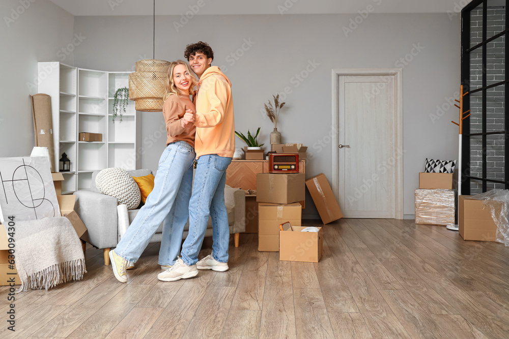 Young couple dancing in room on moving day