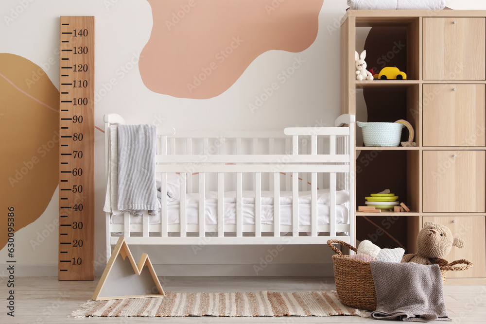 Interior of childrens bedroom with bed and shelving unit