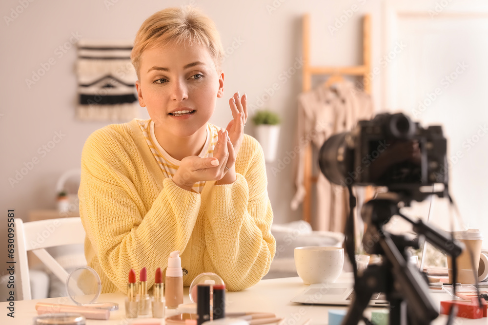 Female beauty blogger recording video at home