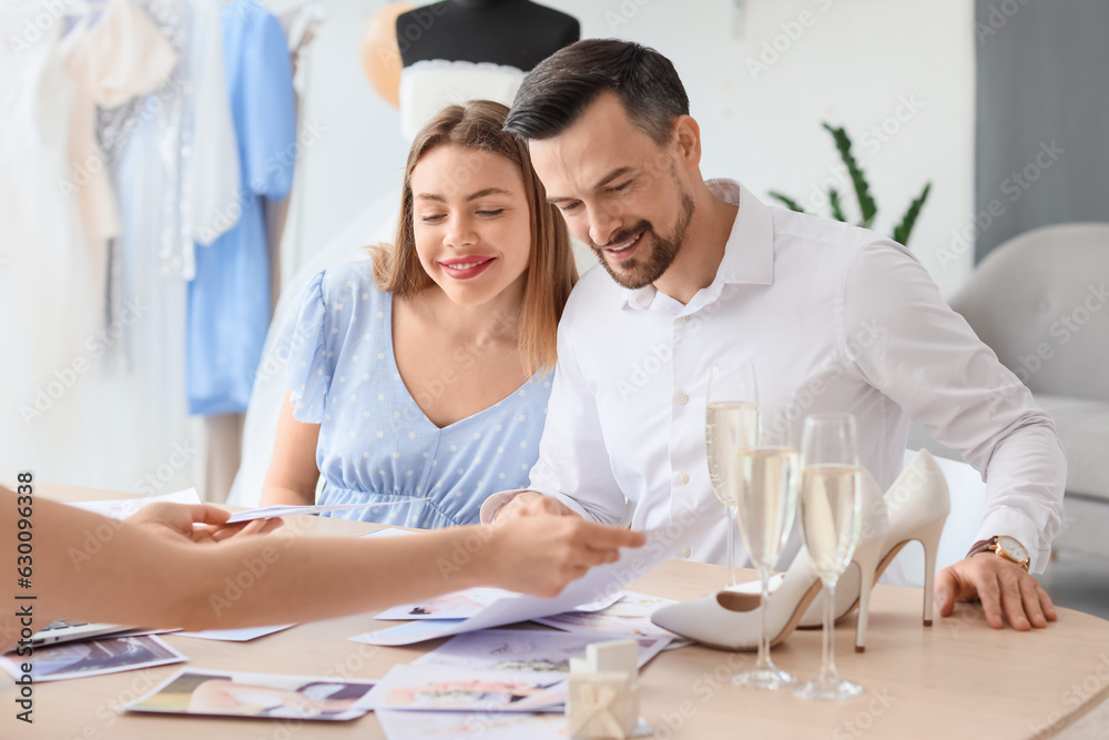 Young couple planning their wedding in office