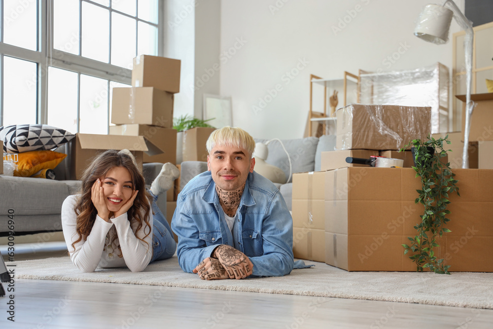 Young couple lying in room on moving day