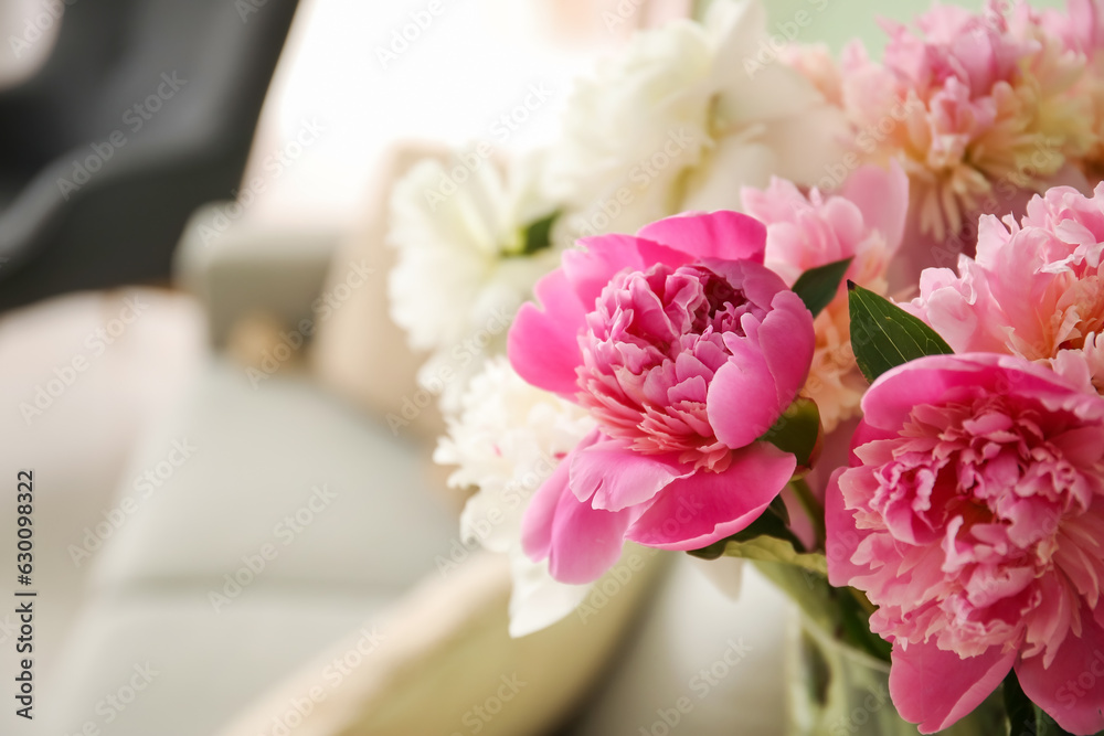 Vase of peonies in living room, closeup