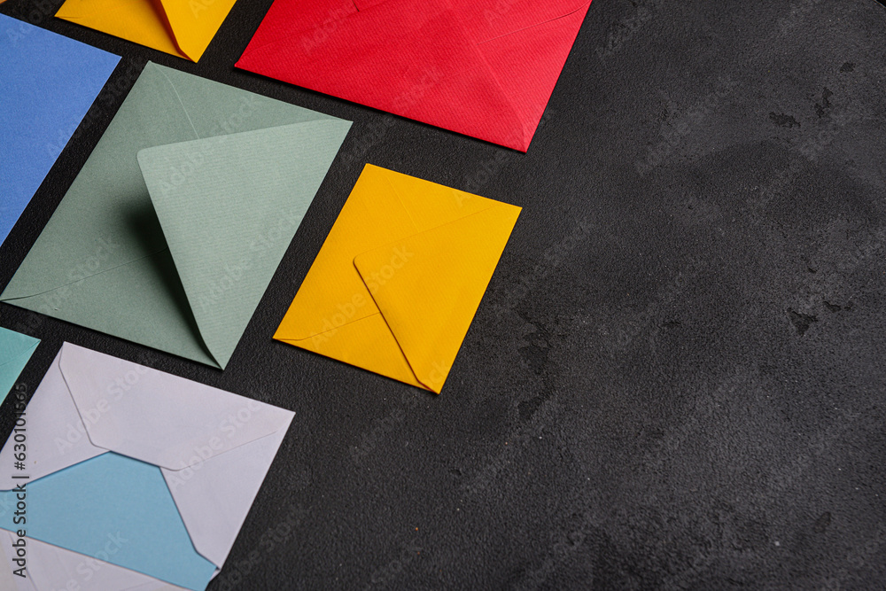 Composition with colorful envelopes on dark background