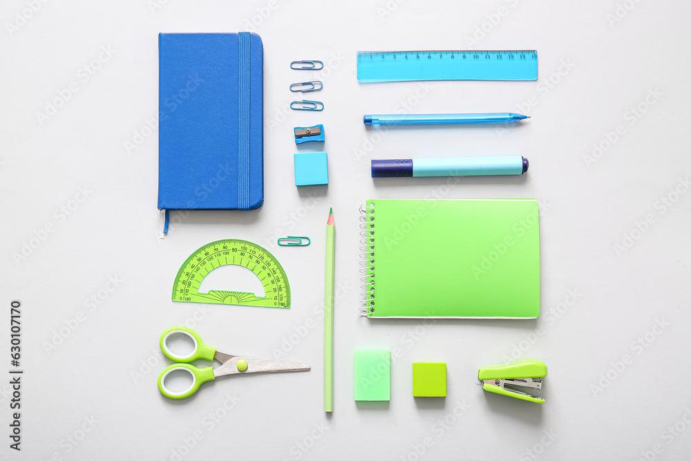 Different school stationery and notebooks on grey background