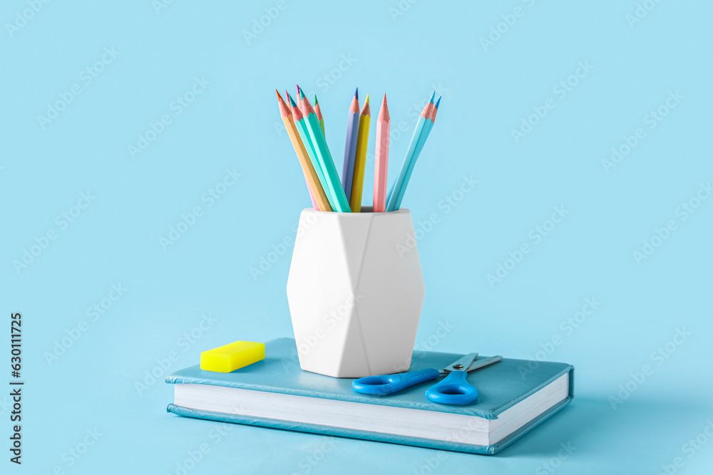 Set of stationery with different pencils on color background