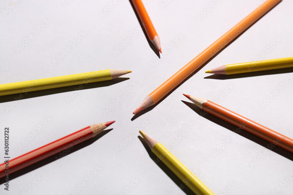 Composition with color pencils on light background, closeup