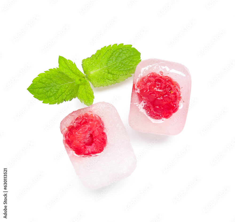 Frozen raspberries in ice cubes and mint on white background