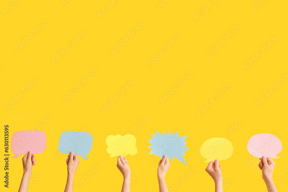 Different hands with speech bubbles on yellow background