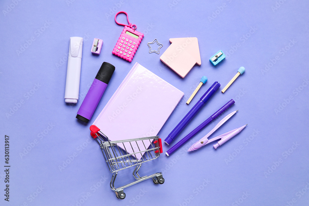 Shopping cart with different school stationery on purple background