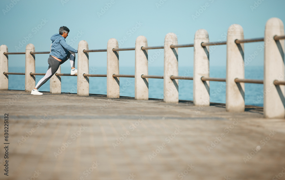 Senior, fitness and woman at the beach stretching for exercise, health and morning cardio routine. L