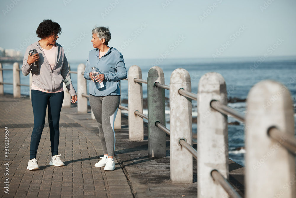 Fitness, walking and women by ocean talking for healthy lifestyle, wellness and cardio on promenade.