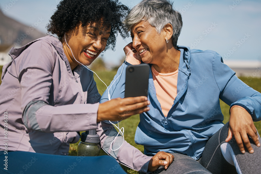 Phone, fitness and music with senior friends on the grass outdoor taking a break from their workout 