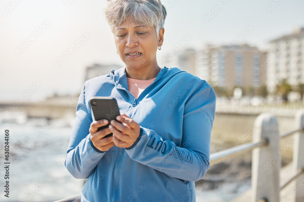 News, phone and fitness with old woman at beach for running, workout and results. Network, communica