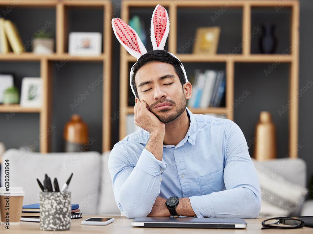 Tired, sleeping and a man for easter in an office with bunny ears for celebration or bored of a part