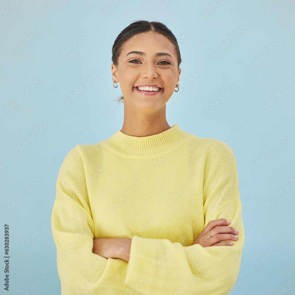 Smile, portrait and woman in studio with arms crossed, fashion and youth mindset on blue background.