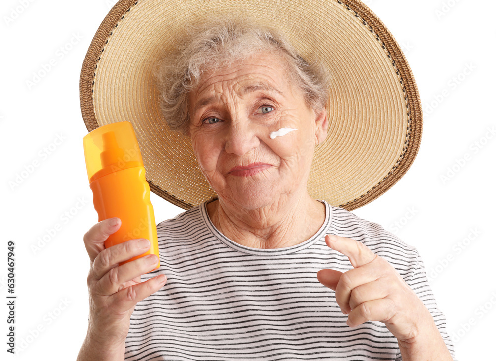 Senior woman pointing at sunscreen cream on white background, closeup