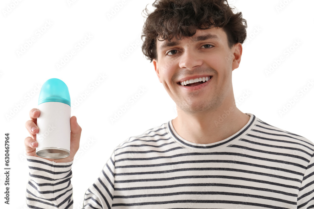 Young man with air freshener in bedroom, closeup