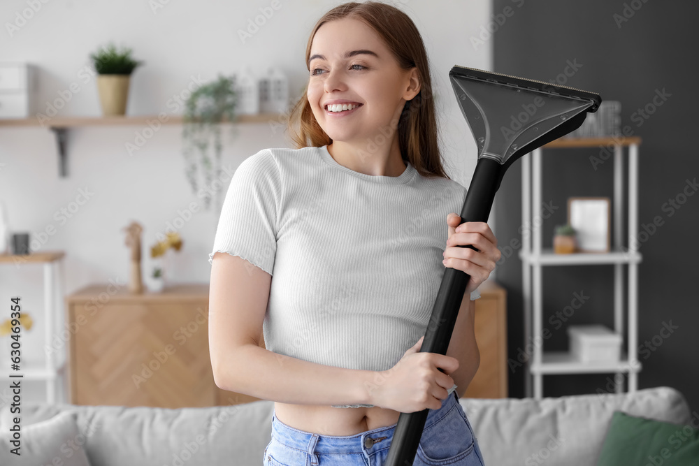 Young woman with vacuum cleaner at home