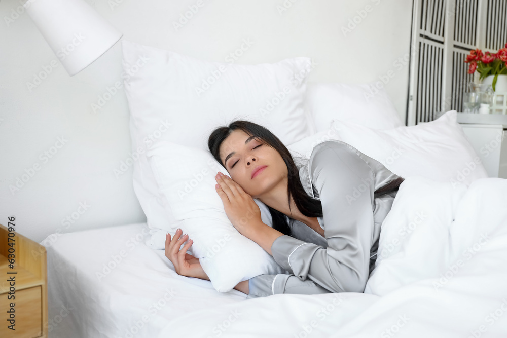 Morning of young woman sleeping in bed