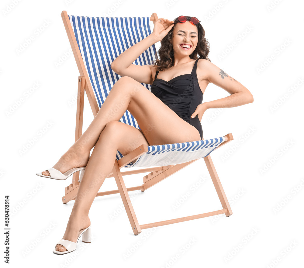 Young woman in deck chair on white background