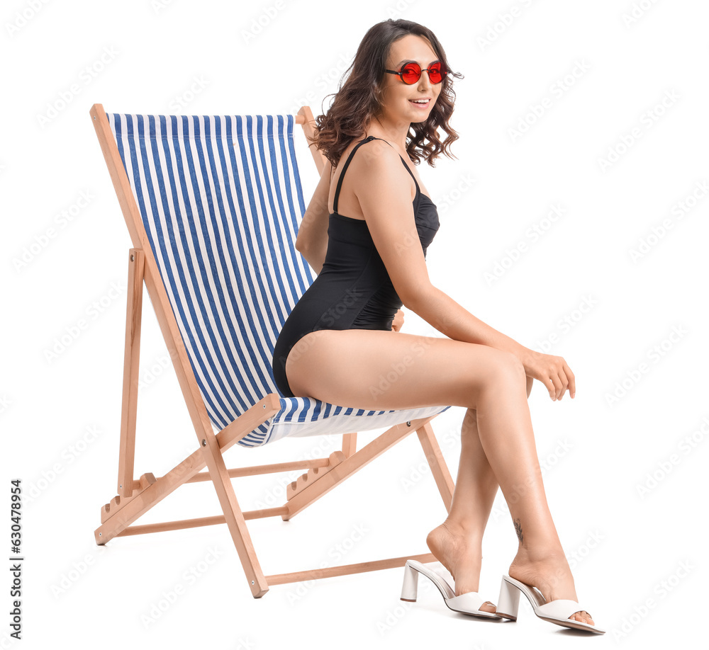 Young woman in deck chair on white background