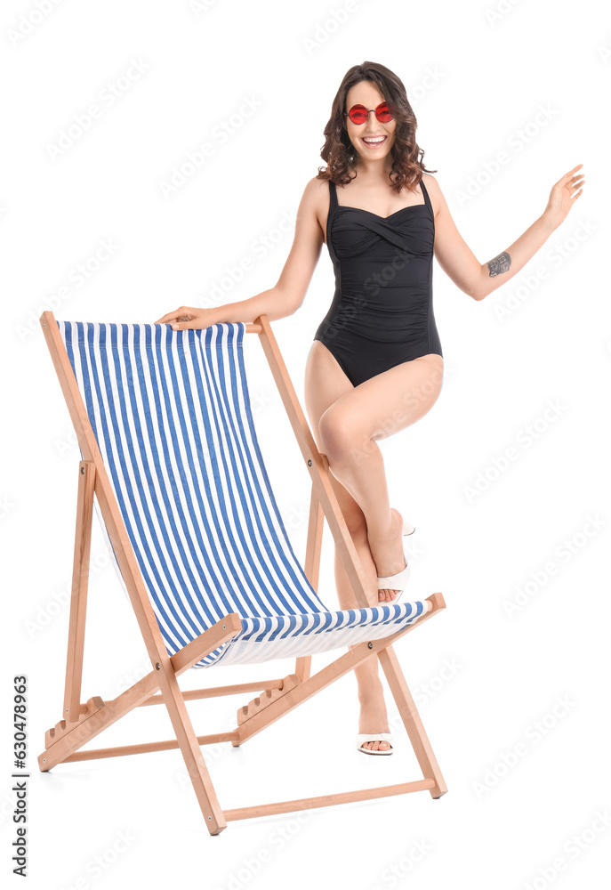 Young woman in deck chair on white background