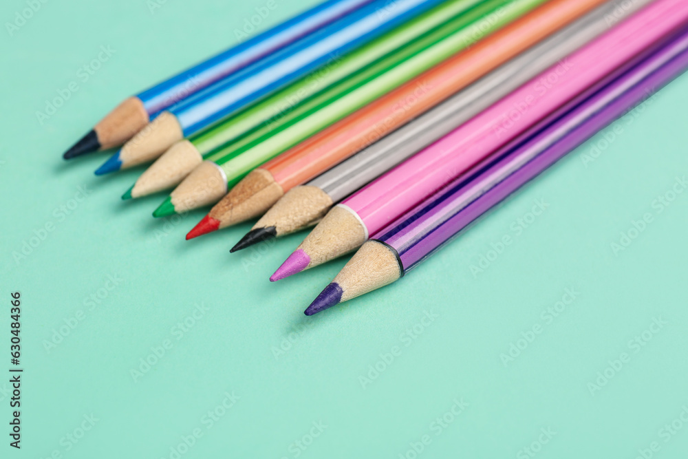 Row of different pencils on color background, closeup