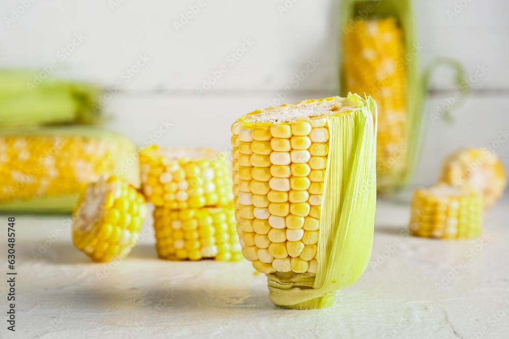 Cut fresh corn cob on white table