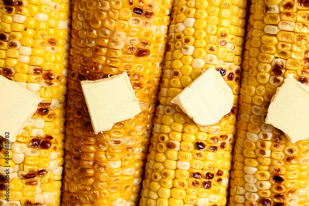 Texture of tasty grilled corn cobs with butter as background