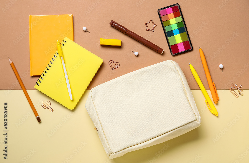 Pencil case with different school stationery on color background