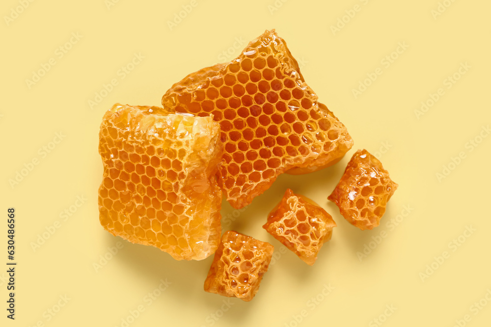 Sweet honeycombs on yellow background