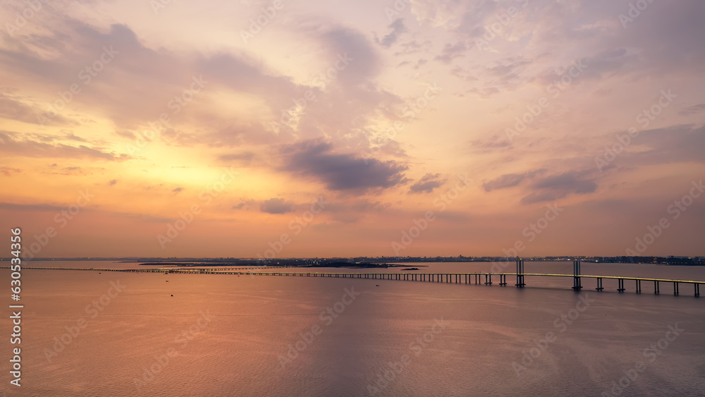 Aerial photo of Qingdao Jiaozhou Bay Cross Sea Bridge under sunset..