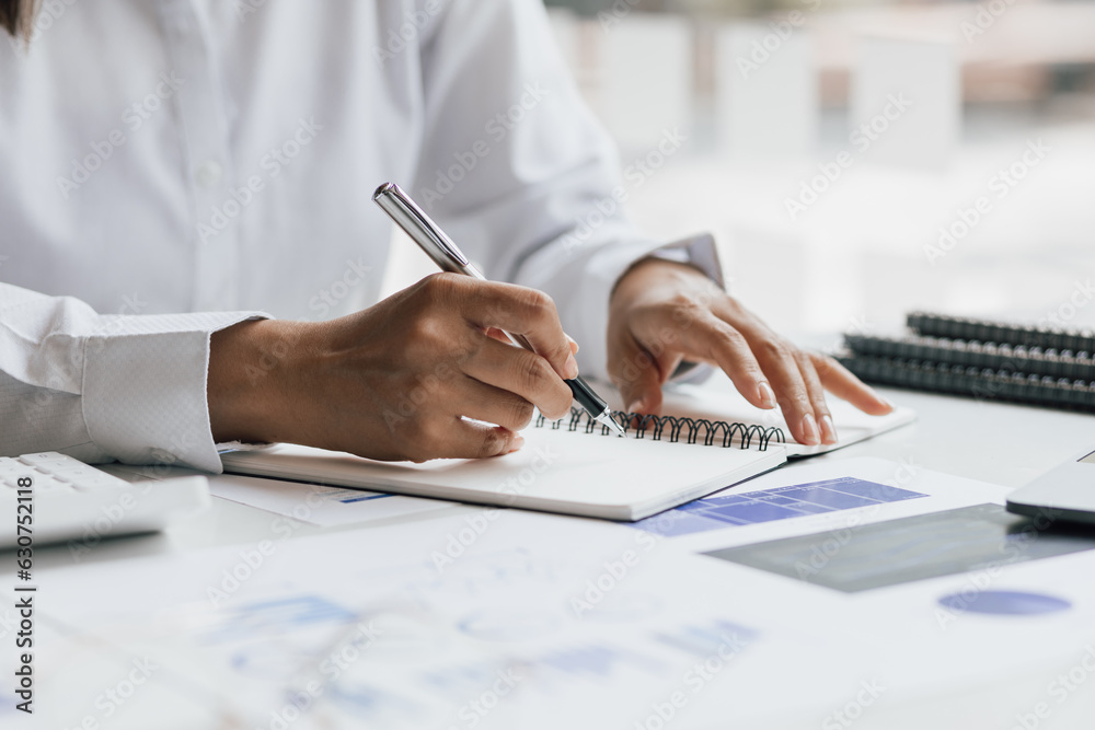 Businesswoman working with laptop and analyzing financial and accounting documents. Business woman w