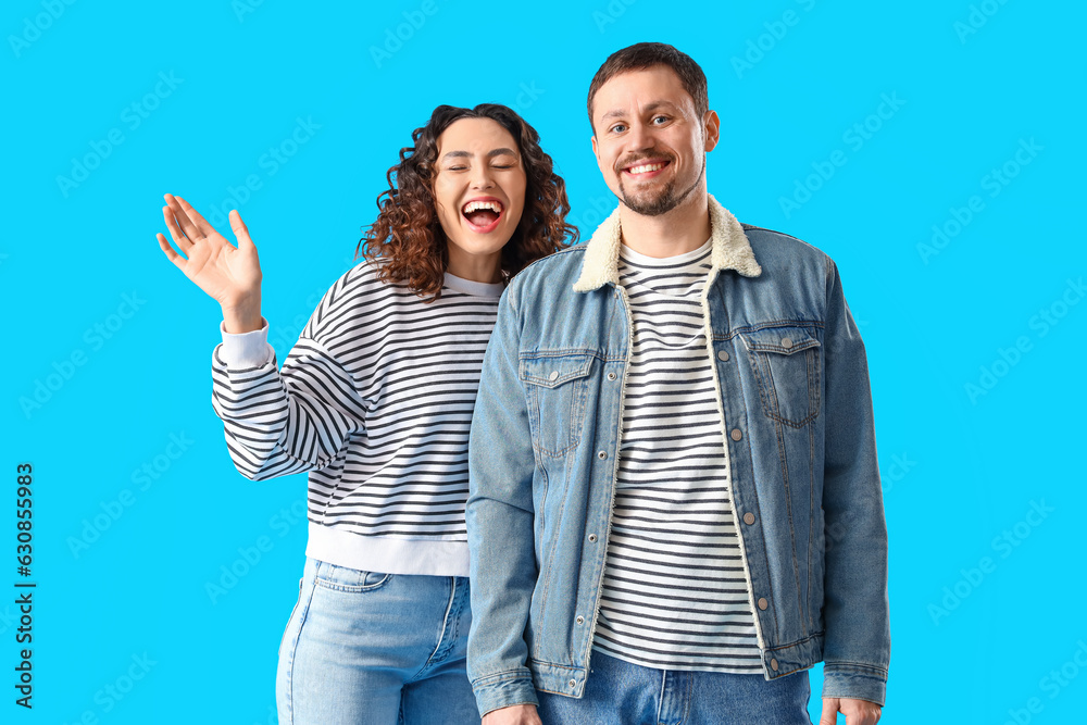 Happy young couple on blue background