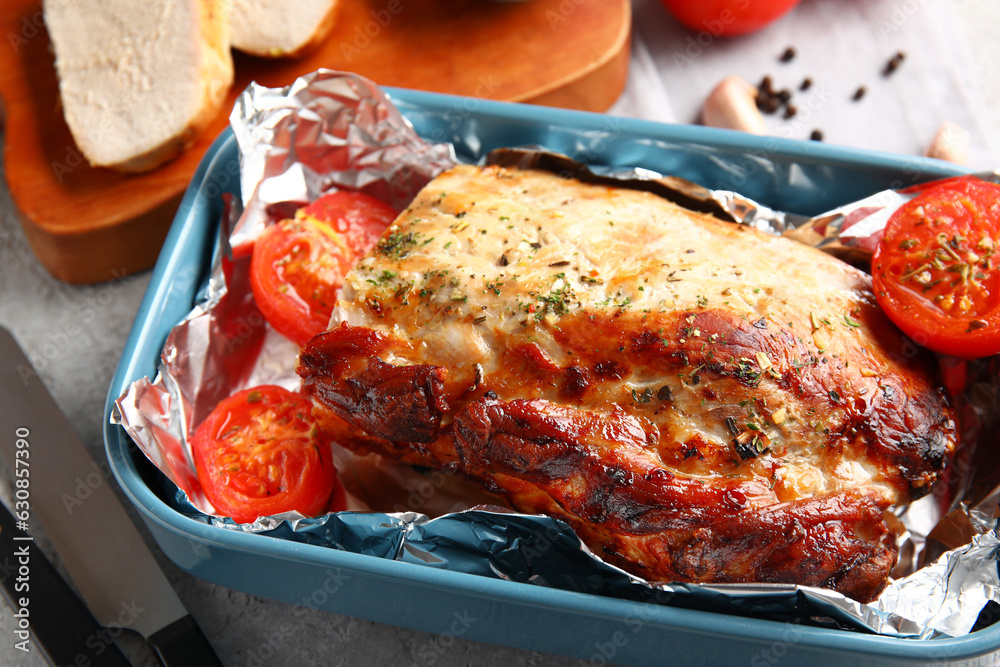 Baking dish with tasty baked meat and tomatoes, closeup