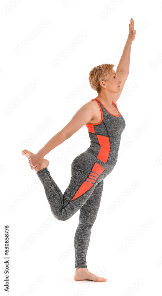 Sporty mature woman practicing yoga on white background