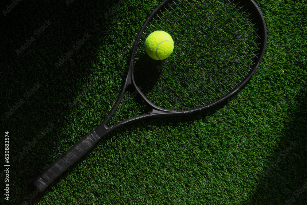 Top view of tennis rackets and ball of green grass. Horizontal sport poster, greeting cards, headers