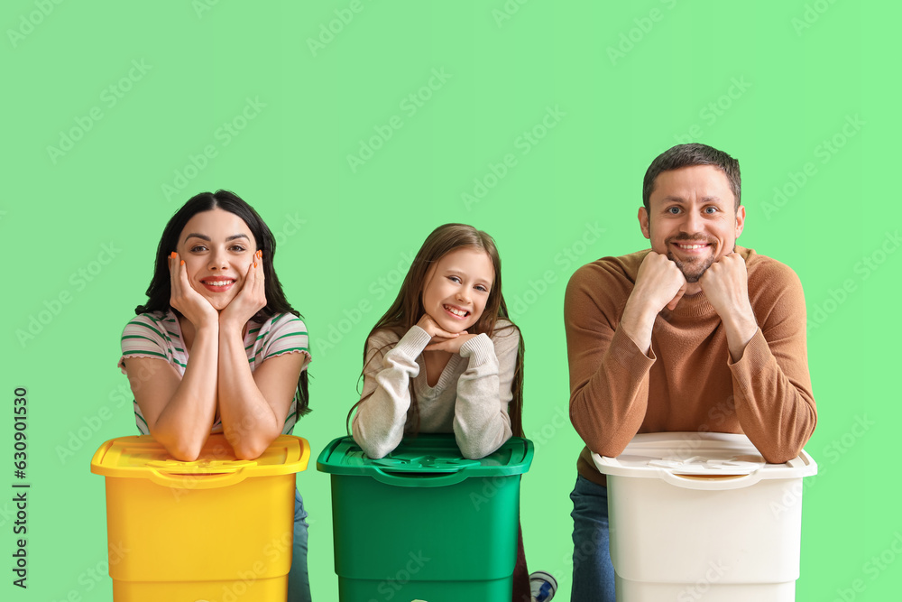 Family with recycle bins on green background