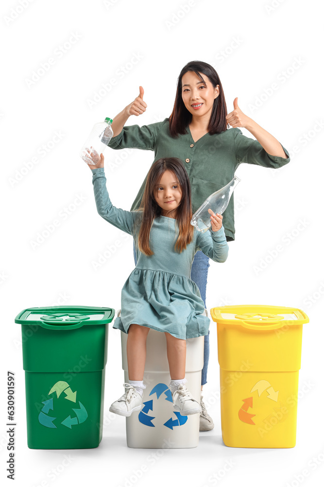 Asian mother with her little daughter and recycle bins on white background